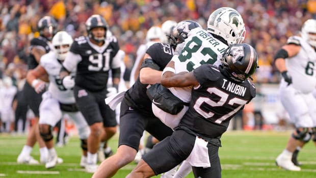 Oct 28, 2023; Minneapolis, Minnesota, USA; Minnesota Golden Gophers defensive back Tyler Nubin (27) and linebacker Ryan Selig (33) prevent Michigan State Spartans wide receiver Montorie Foster Jr. (83) from converting on a two-point try during the fourth quarter at Huntington Bank Stadium. 